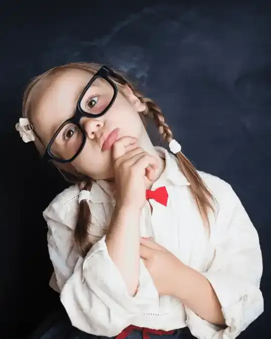 A child wearing glasses, thoughtful expression